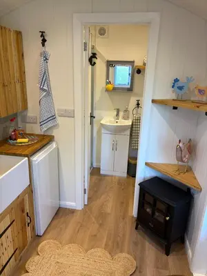 a small kitchen with a sink and a counter top at Shepherds hut in Holywell Cambridgeshire in Holywell