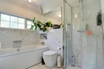 a bathroom with a tub and a toilet and a shower at Charming 4 bedroom home in Felsted in Felsted
