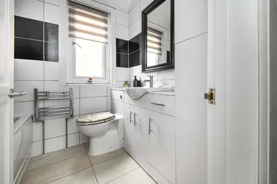 a white bathroom with a toilet and a sink at The Pier Escape Sea Breaze Stay in Clacton-on-Sea