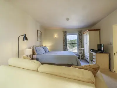 a bedroom with a large bed and a couch at Over Village Studio in Cambridge