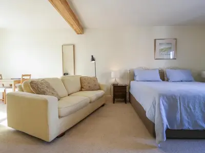 a living room with a couch and a bed at Over Village Studio in Cambridge