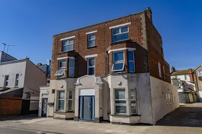 a large brick building on a city street at Coral Bay Seaside Aparto in Clacton-on-Sea