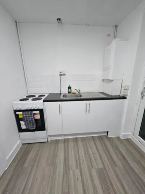 a white kitchen with a sink and a stove at Coral Bay Seaside Aparto in Clacton-on-Sea