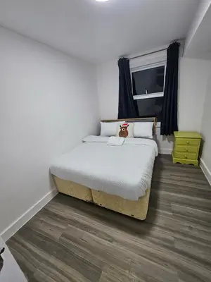 a bedroom with a bed with a teddy bear on it at Coral Bay Seaside Aparto in Clacton-on-Sea