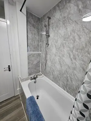 a bathroom with a bath tub with a shower at Coral Bay Seaside Aparto in Clacton-on-Sea