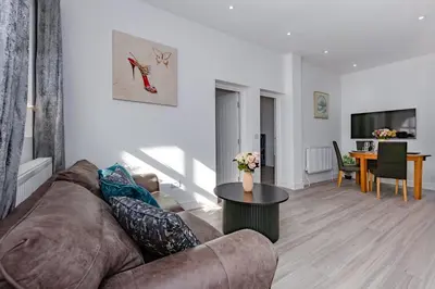 a living room with a couch and a table at Blue Horizon Seaside Apart in Clacton-on-Sea