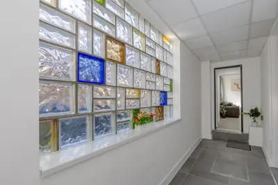 a wall of stained glass windows in a hallway at Blue Horizon Seaside Apart in Clacton-on-Sea