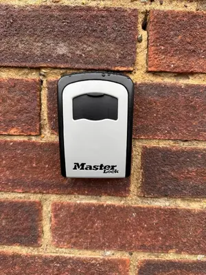 a white toaster on the side of a brick wall at Jayjay Guest House in Basildon