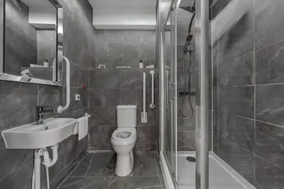 a bathroom with a toilet and a sink and a shower at Triple B Aparto in Clacton-on-Sea