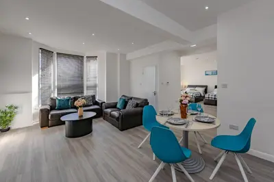 a living room with a couch and a table and chairs at Triple B Aparto in Clacton-on-Sea