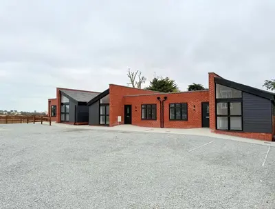 a group of buildings with a parking lot at Rural Retreats 9 and 10 in Southminster