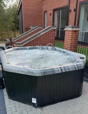 a large hot tub in front of a building at Rural Retreats 9 and 10 in Southminster