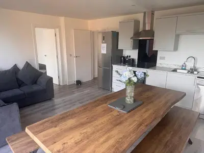 a kitchen and a living room with a wooden table at Rural Retreats 9 and 10 in Southminster