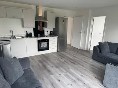 a kitchen and living room with a couch and a refrigerator at Rural Retreats 9 and 10 in Southminster