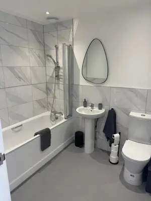 a bathroom with a sink and a tub and a toilet at Rural Retreats 9 and 10 in Southminster