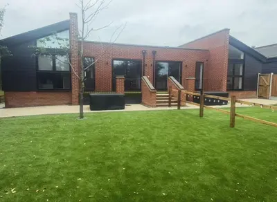 a brick building with a lawn in front of it at Rural Retreats 9 and 10 in Southminster