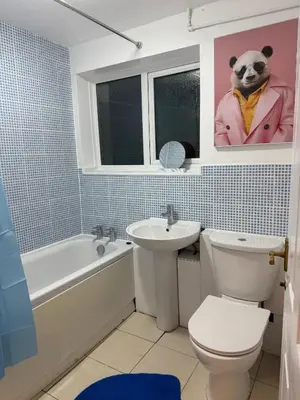 a bathroom with a sink and a toilet and a bath tub at 3 Bed Home, Sleeps 7 with Garden in Basildon in Basildon