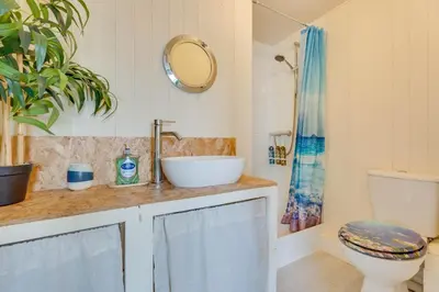 a bathroom with a sink and a toilet at The Old Shoe Shop, 5 Well Lane in Clare