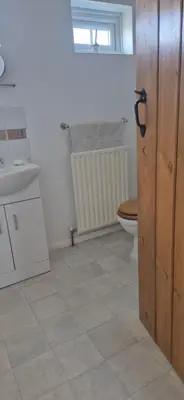 a bathroom with a toilet and a sink at Cambridgeshire Cosy Cottage in Cottenham