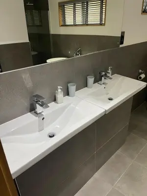 a bathroom with a white sink and a mirror at Contemporary 3 bed luxury Spa lodge with hot tub in Bury Saint Edmunds
