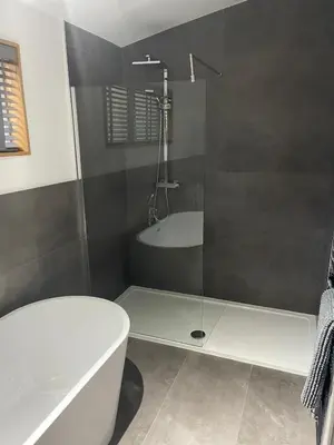 a bathroom with a shower and a tub and a toilet at Contemporary 3 bed luxury Spa lodge with hot tub in Bury Saint Edmunds