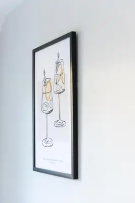 a framed drawing of wine glasses on a wall at 4 Bedroom Home - 2 Mins to Town CM7 - Contractor Ready in Braintree
