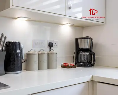 a kitchen counter with four coffee cans on it at Luxury Five-Bedroom Home with Jacuzzi and Gym - Private One-Bedroom Garden Suite Available Separately in Basildon