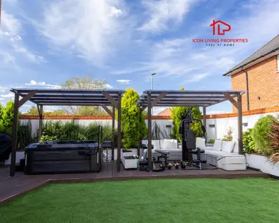 a pergola in a backyard with a lawn at Luxury Five-Bedroom Home with Jacuzzi and Gym - Private One-Bedroom Garden Suite Available Separately in Basildon