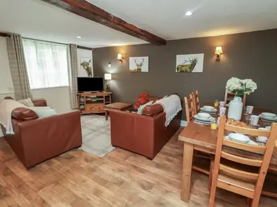 a living room with two couches and a table at Duchess Cottage in Woodbridge