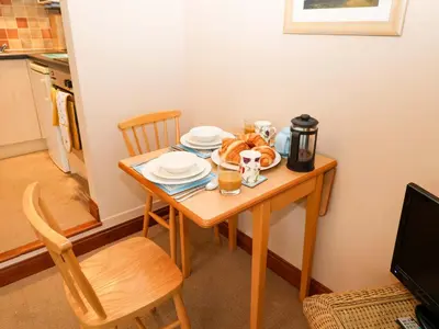 a table with plates of food on it in a kitchen at Hayloft in Ipswich