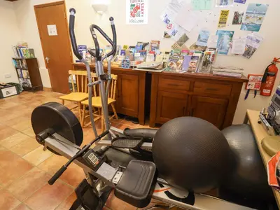 a room with a gym with a exercise bike at Hayloft in Ipswich