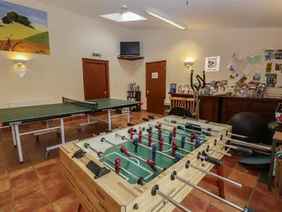 a room with ping pong tables and ping pong balls at Fisherman's Rest in Ipswich