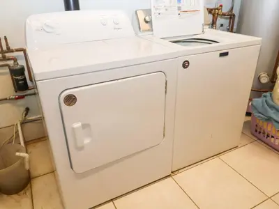 a white washer and dryer in a kitchen at Coachman's Cottage in Ipswich