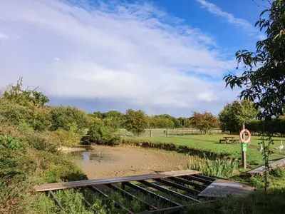 a set of train tracks next to a field at Coachman's Cottage in Ipswich