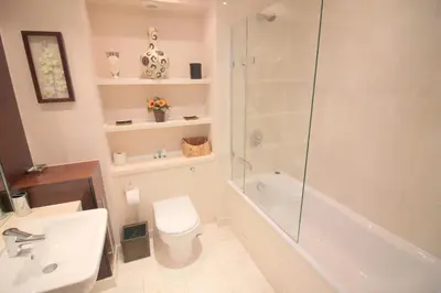 a bathroom with a shower toilet and a sink at The Luxurious Penthouse in Cambridge