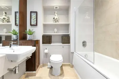 a bathroom with a sink and a toilet and a shower at The Luxurious Penthouse in Cambridge