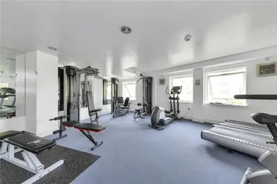 a gym with several exercise equipment in a room at The Luxurious Penthouse in Cambridge