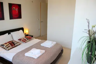 a bedroom with a bed with two towels on it at The Luxurious Penthouse in Cambridge