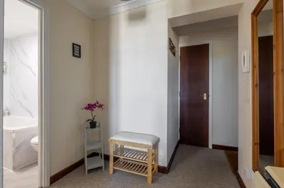 a bathroom with a toilet and a stool in it at 1Bed Central Apt With Parking in Chesterton