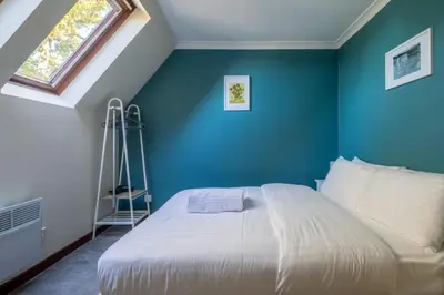 a bedroom with a bed with a blue wall at 1Bed Central Apt With Parking in Chesterton