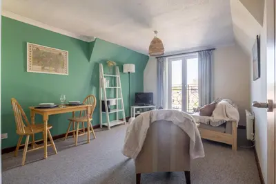 a bedroom with green walls and a desk and a bed at 1Bed Central Apt With Parking in Chesterton