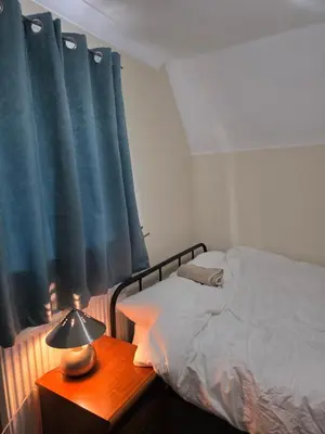 a bedroom with a bed and a table with a lamp at Colchester Comfortable room Oo in Hythe