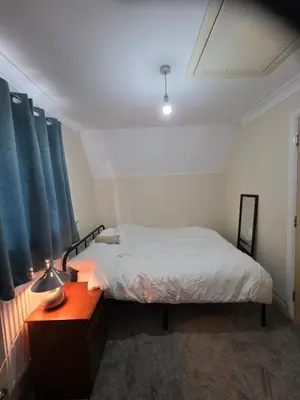 a bedroom with a bed and a desk with a lamp at Colchester Comfortable room Oo in Hythe