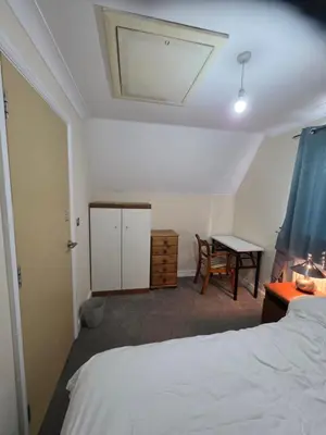 a bedroom with a bed and a desk and a table at Colchester Comfortable room Oo in Hythe