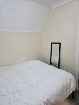 a bedroom with a white bed and a mirror at Colchester Comfortable room Oo in Hythe