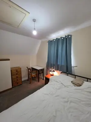 a bedroom with a bed and a desk and a table at Colchester Comfortable room Oo in Hythe