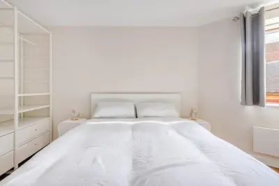 a white bedroom with a large white bed at Chic escape in Cambridge