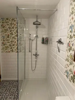 a shower with a glass door in a bathroom at The Old Scullery in Bungay
