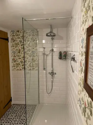 a shower with a glass door in a bathroom at The Old Scullery in Bungay