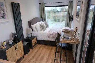 a bedroom with a bed and a table and a window at The Granary Estates